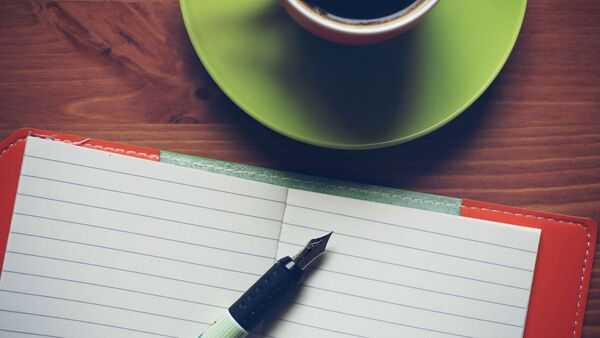 A notebook and pen on a desk, suggesting a simple planning moment